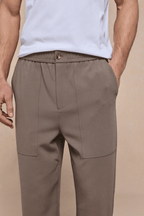 Men's olive Julien relaxed panelled trousers with an elasticated waist, button fastening, and side pockets.