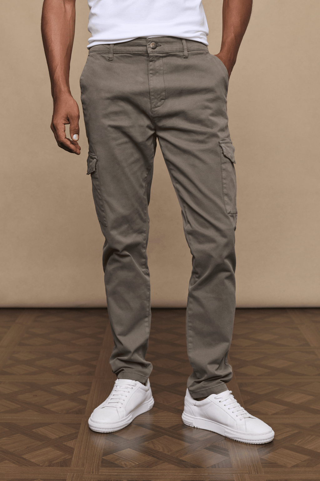 Men's Lenox Cargo pants in dark olive, straight leg, with utility pockets and white sneakers.