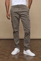 Men's Lenox Cargo pants in dark olive, straight leg, with utility pockets and white sneakers.