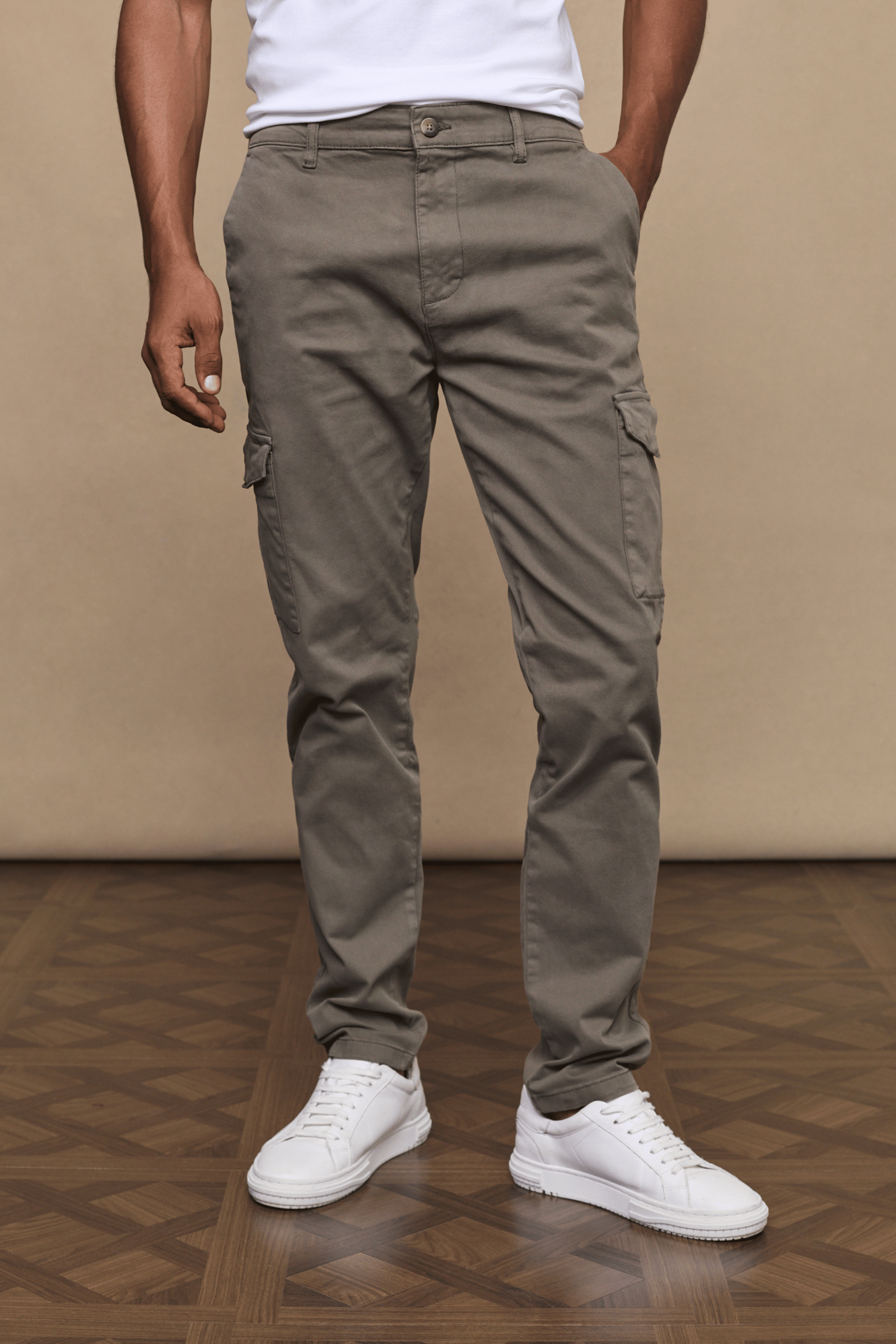 Men's Lenox Cargo pants in dark olive, straight leg, with utility pockets and white sneakers.