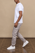 Man in Lenox Cargo Greige pants with utility pockets, straight leg, and white t-shirt.