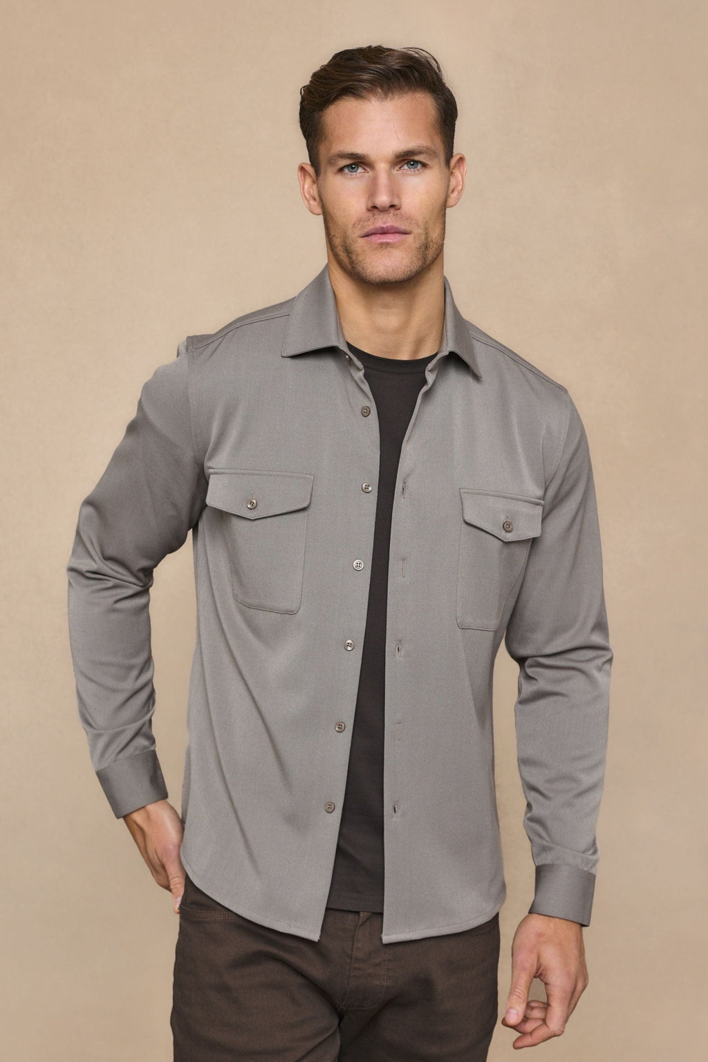 Leo Overshirt in warm grey, soft stretchy fabric, dual chest pockets, tonal buttons, worn over a dark tee.