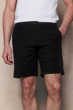 Black Luiz Hybrid Shorts with tailored chino look, elasticated back, and concealed zip pockets.