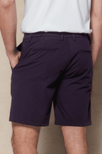 Man wearing navy Luiz Hybrid Shorts with tailored finish, elasticated back, and concealed zip pockets.