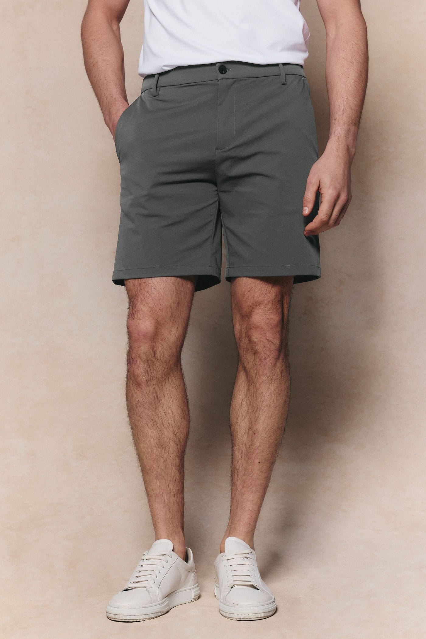 Man wearing sage green Luiz Hybrid Shorts with a tailored finish, elasticated back, and six-pocket design.