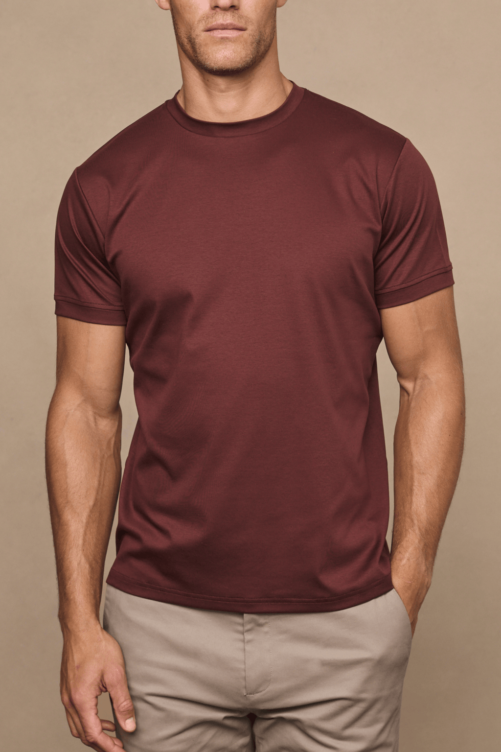 Men's Luxe Mercerised Cotton Crew-Neck T-Shirt in Rust, paired with beige trousers.