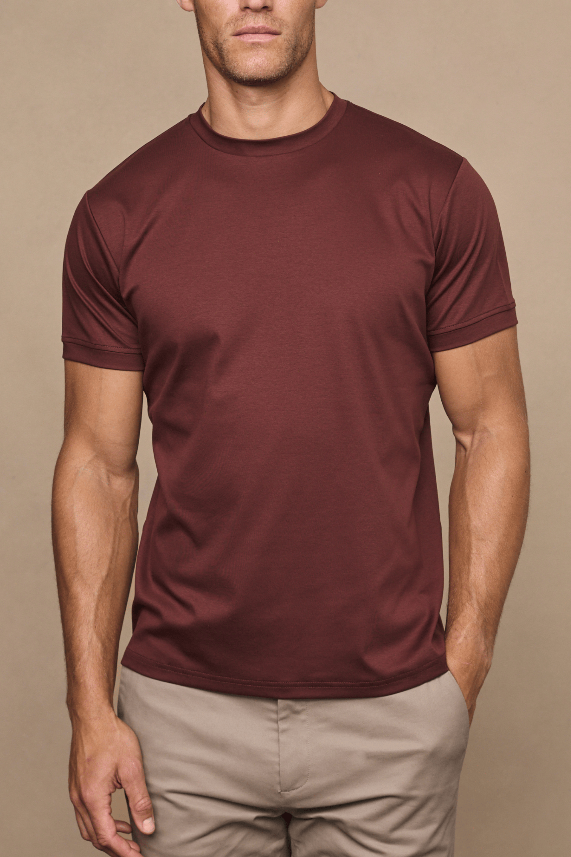 Men's Luxe Mercerised Cotton Crew-Neck T-Shirt in Rust, paired with beige trousers.