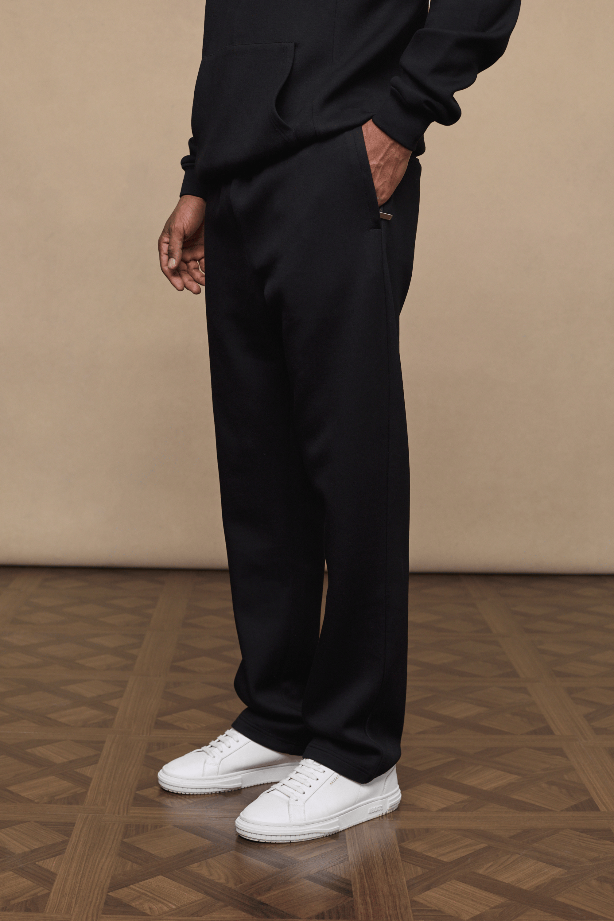 Black Luxe Straight Leg Jogger, made from soft 380gsm fabric, with a subtle sheen and side pockets.