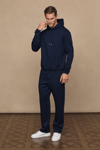 Man wearing a navy Luxe Straight Leg Jogger and matching hoodie, featuring a subtle sheen and clean silhouette.