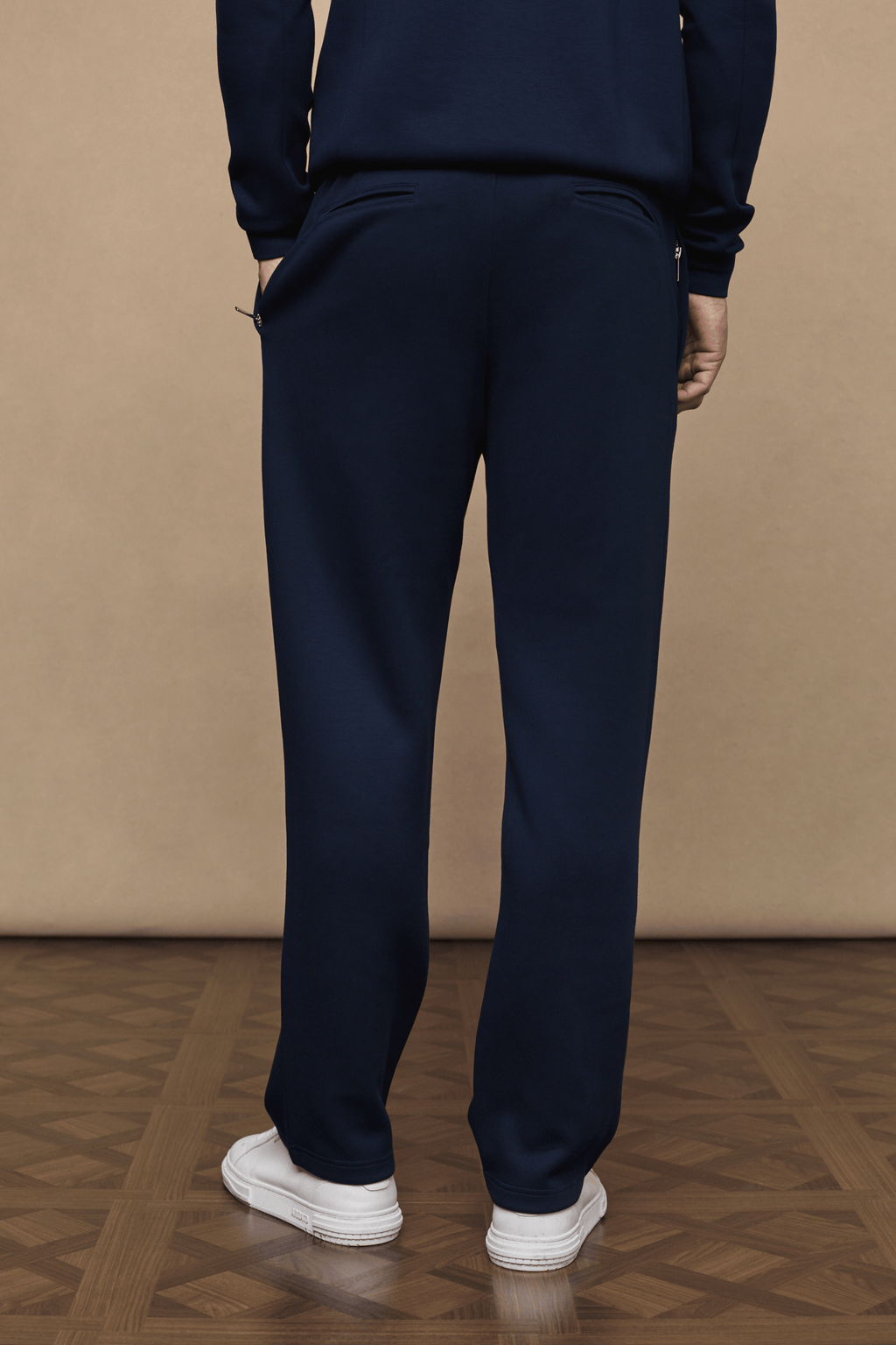 Navy Luxe Straight Leg Jogger, crafted from soft fabric with a subtle sheen, featuring side pockets and metal hardware.