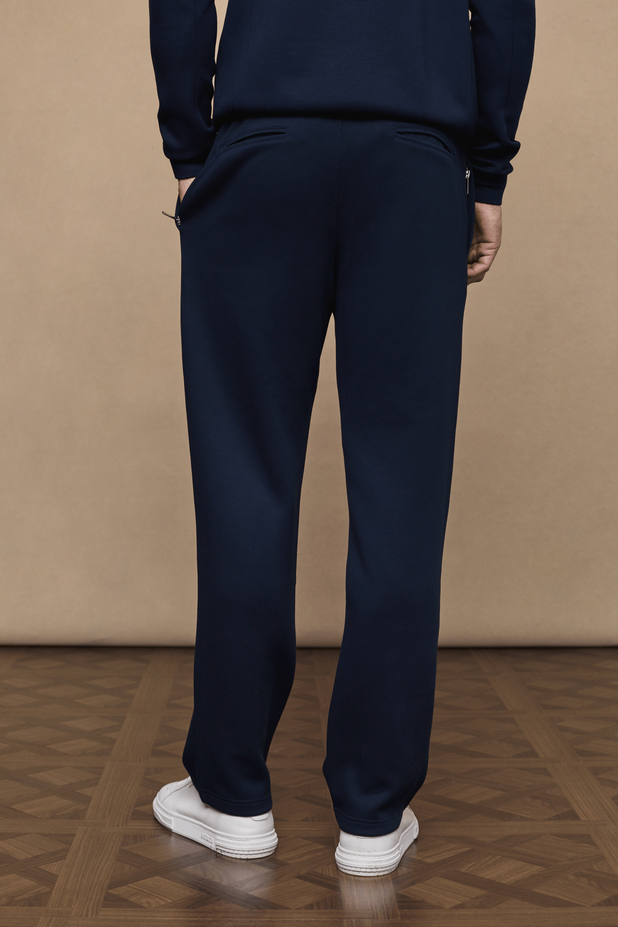 Navy Luxe Straight Leg Jogger, crafted from soft fabric with a subtle sheen, featuring side pockets and metal hardware.