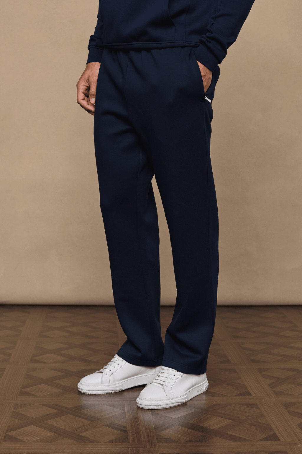 Navy Luxe Straight Leg Jogger, soft fabric, side pockets, paired with white sneakers.