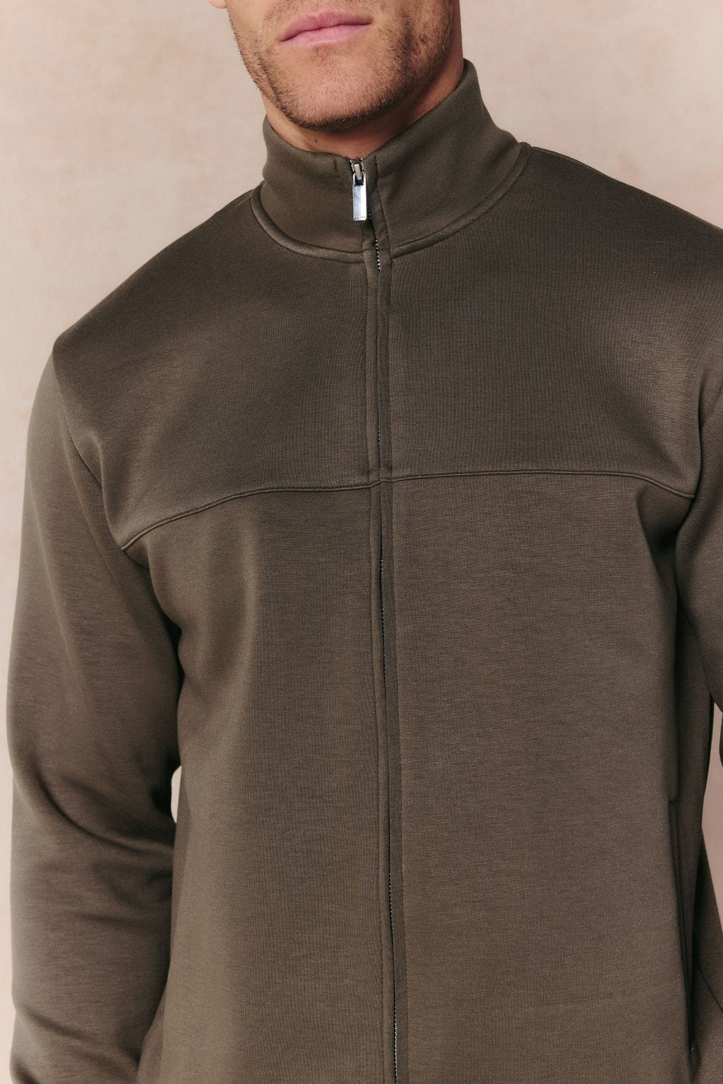 Men's Luxe Zip Through Jacket in Burnt Olive, featuring a stand collar, metal zipper, and paneled design.