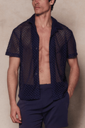 Man wearing an open navy Marcelo short sleeve lace shirt with a textured, open-knit cotton fabric and navy shorts.