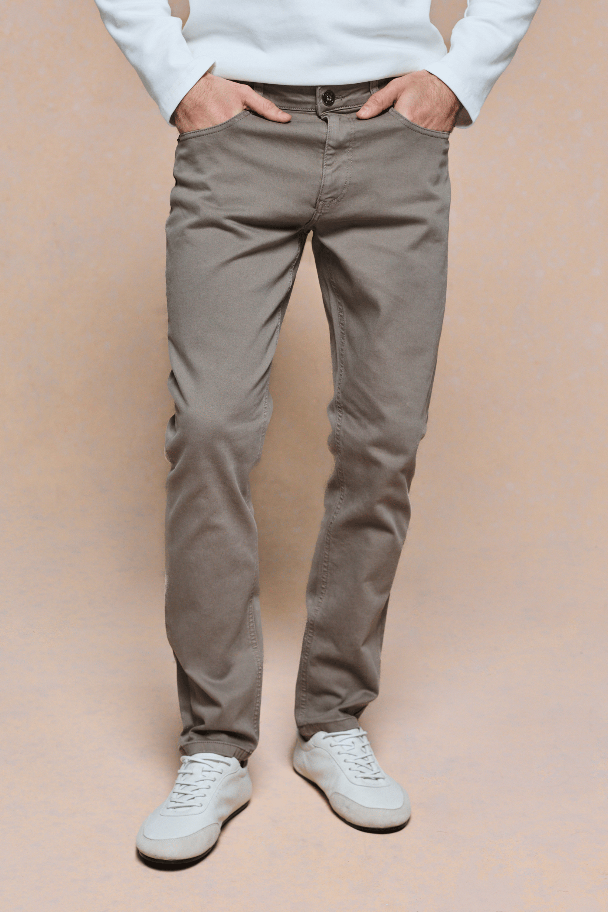 Marco Jean in Burnt Olive, straight-slim fit, 98% cotton denim, with white sneakers.