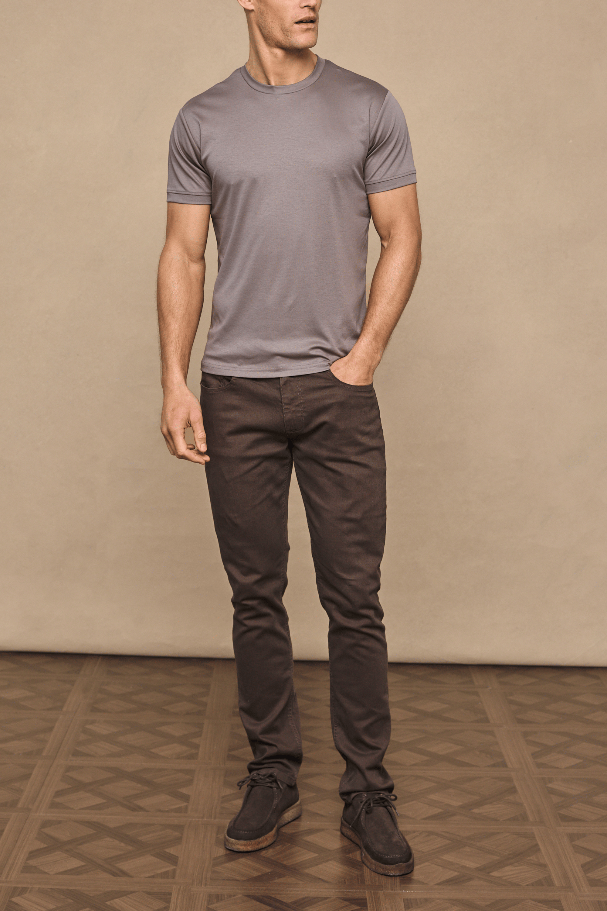 Man wearing dark brown Marco Jean and a grey t-shirt, showcasing the straight-slim fit.
