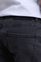 Marco Washed Jean in light washed black, showing back pockets and a dyed-to-match leather patch.