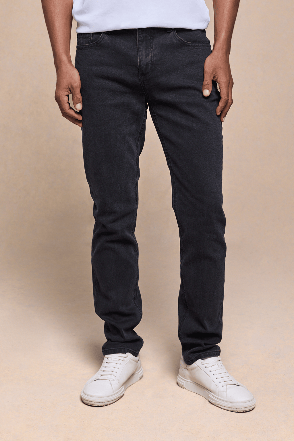 Men's Marco Washed Jean in light washed black denim, straight-slim fit, with white sneakers.