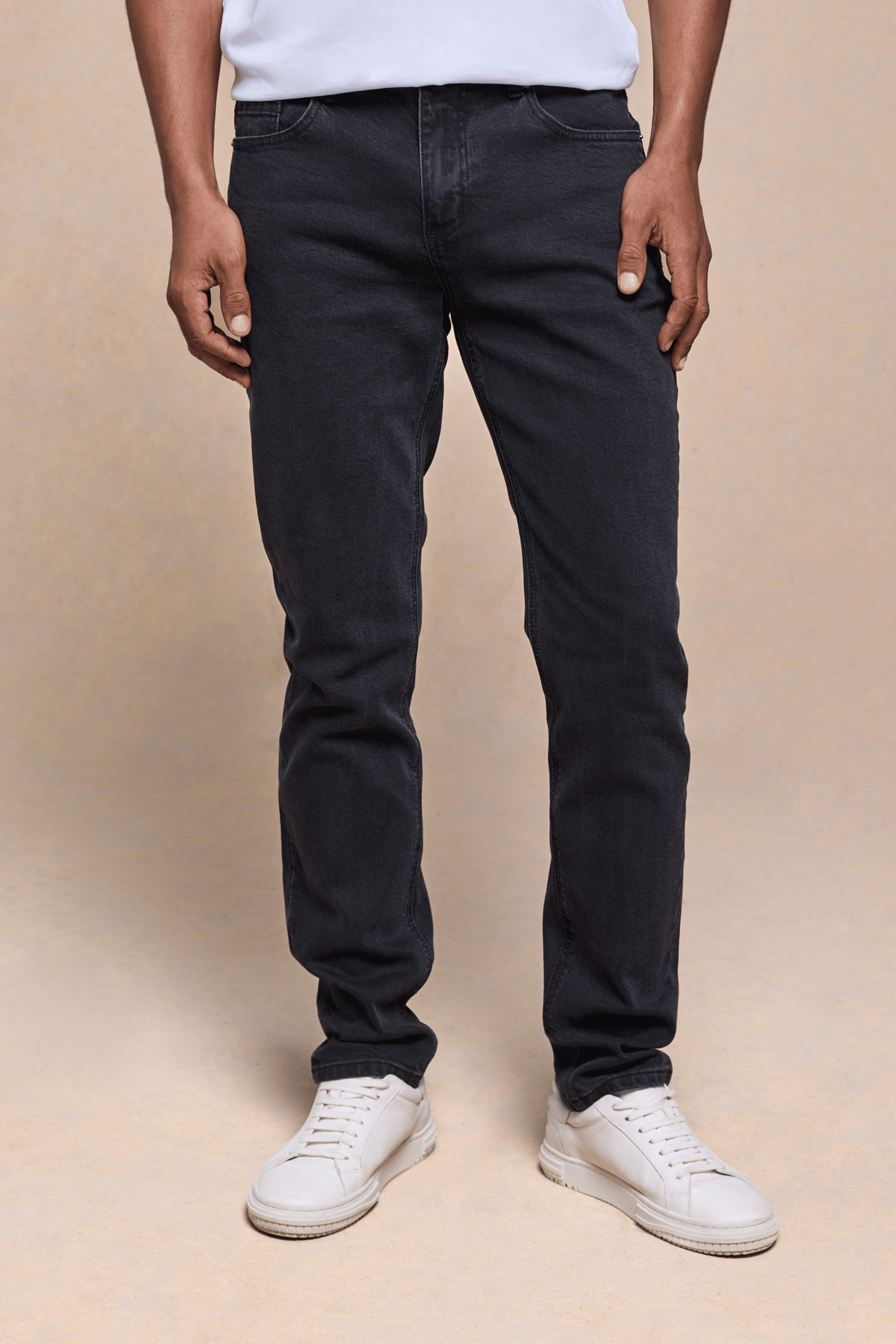 Men's Marco Washed Jean in light washed black denim, straight-slim fit, with white sneakers.