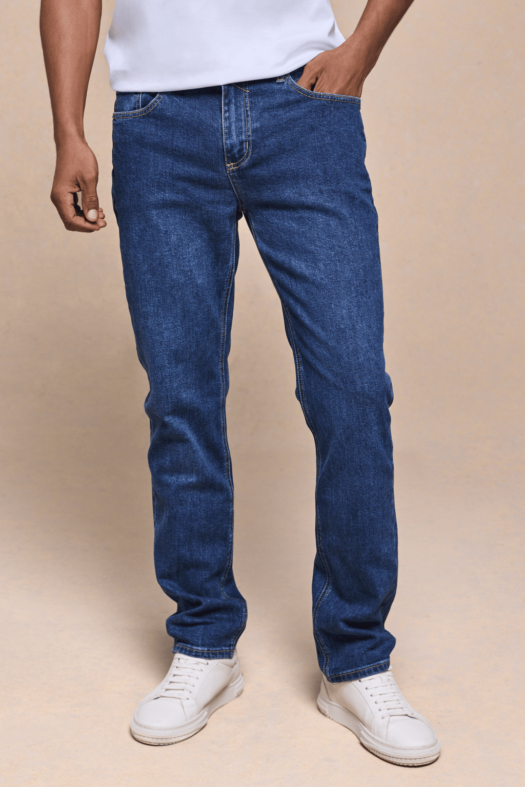 Men's Marco Washed Jean in mid wash indigo, straight-slim fit, with a leather back patch and metal hardware.