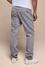 Man wearing Marco Washed Jean in Stone Grey, showing the straight-slim fit, back pockets, and leather patch.