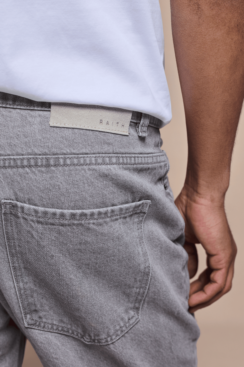 Marco Washed Jean in Stone Grey, showing the back pocket, belt loops, and branded leather patch.