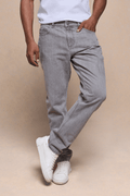 Man wearing Marco Washed Jean in Stone Grey, a straight-slim fit cotton-elastane denim with white sneakers.