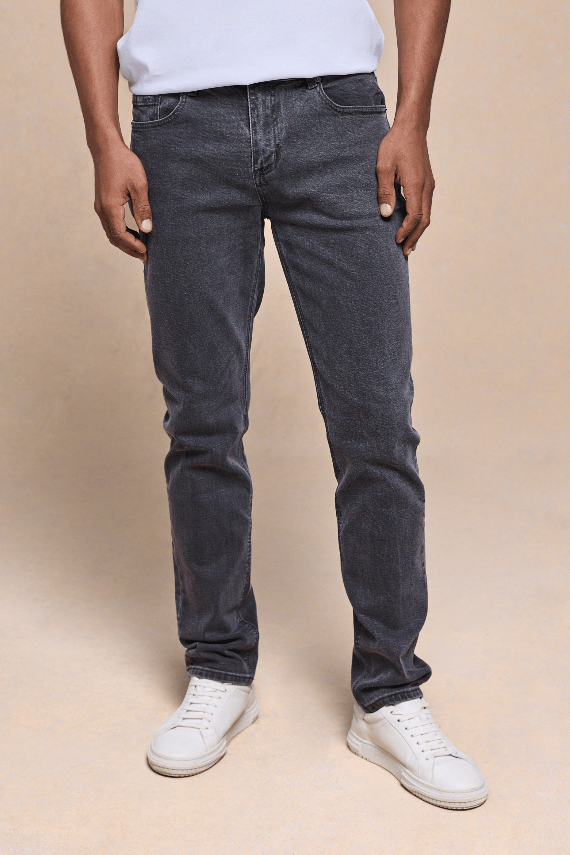 Men's Marco Washed Jean in Washed Grey, straight-slim fit, cotton-elastane denim, with white sneakers.