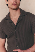 Man wearing a brown Marcos patterned waffle short sleeve shirt with an open collar and button-through front.