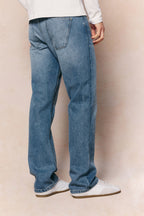 Mason relaxed fit midwash indigo jeans made from 100% cotton denim with a tan leather back patch.