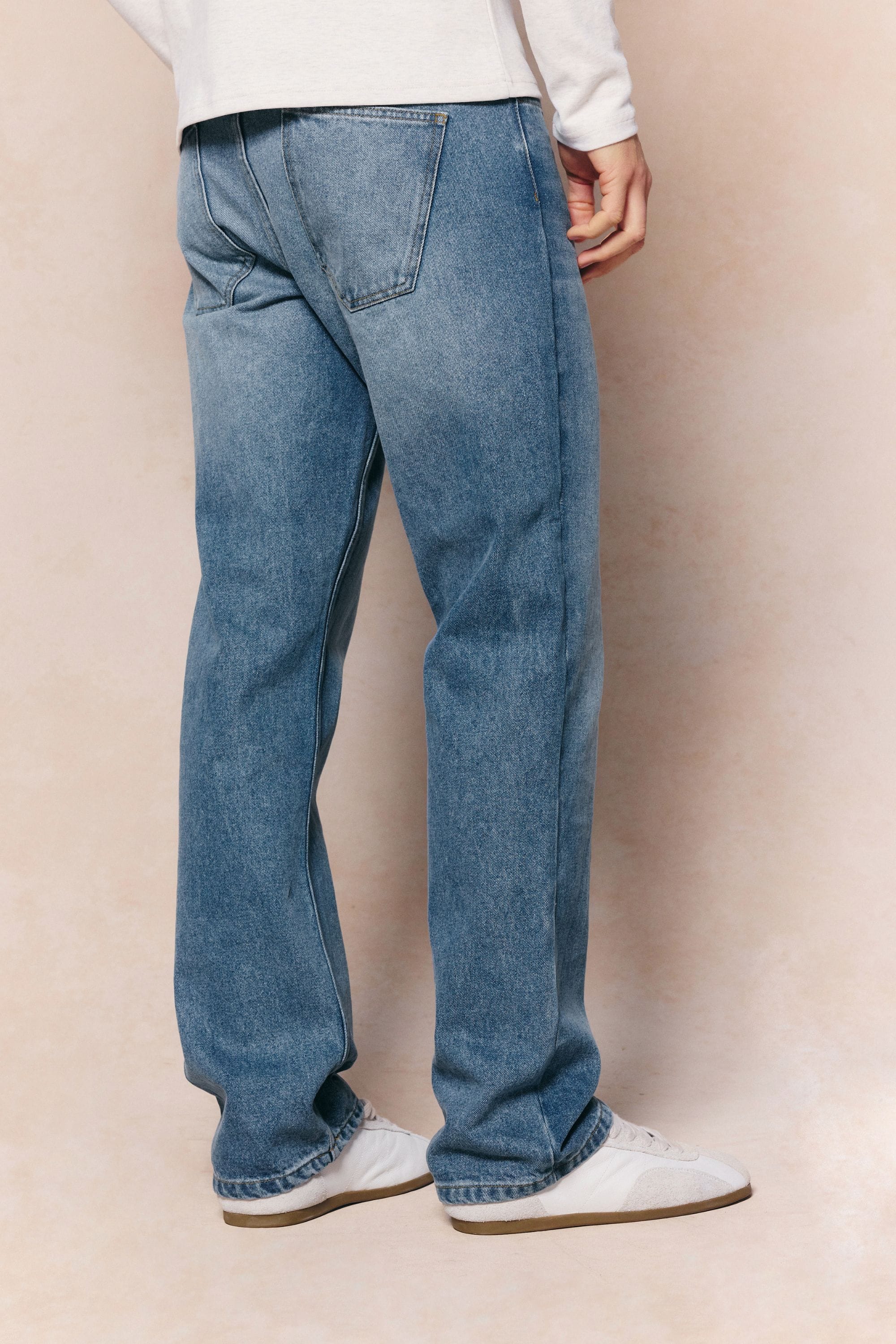 Mason relaxed fit midwash indigo jeans made from 100% cotton denim with a tan leather back patch.