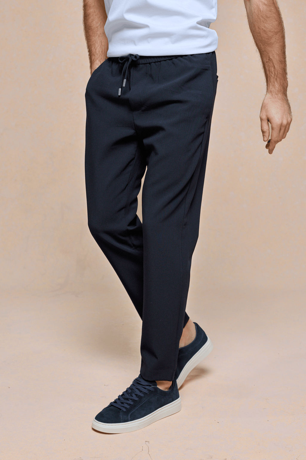 Mateo Tapered Trouser in dark navy, featuring an elasticated drawcord waistband and a clean, tapered silhouette.