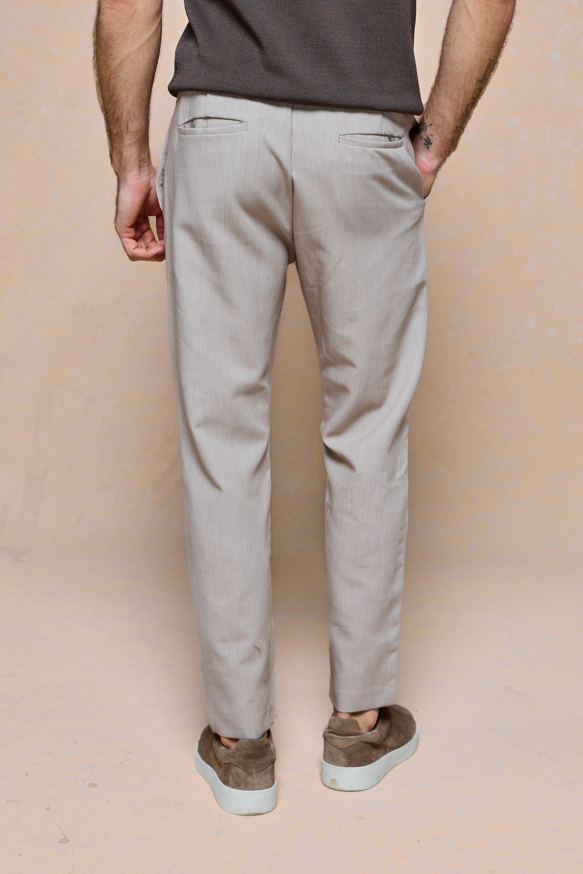 Mateo Tapered Trouser in Oatmeal Marl, shown from behind, featuring a clean, tapered silhouette and elasticated drawcord waistband.