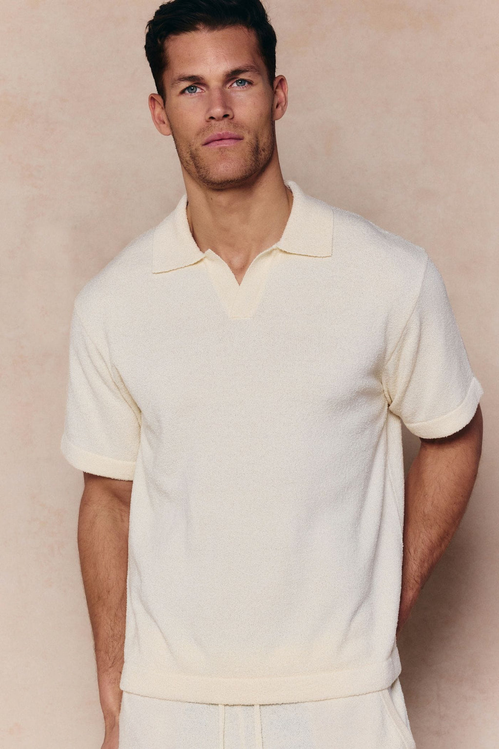 Man wearing an ecru Miguel Boucle Polo Shirt with a clean open collar and relaxed fit.