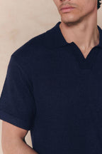 Navy Miguel Boucle Polo Shirt with a textured fabric and clean open collar, worn by a man.