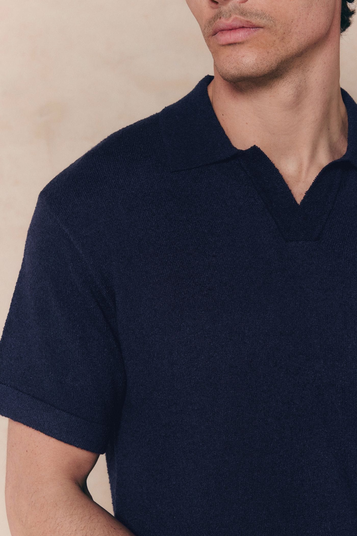 Navy Miguel Boucle Polo Shirt with a textured fabric and clean open collar, worn by a man.