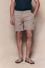 Milo Cargo Tech Shorts in beige, featuring an elasticated drawstring waist and side patch pockets.