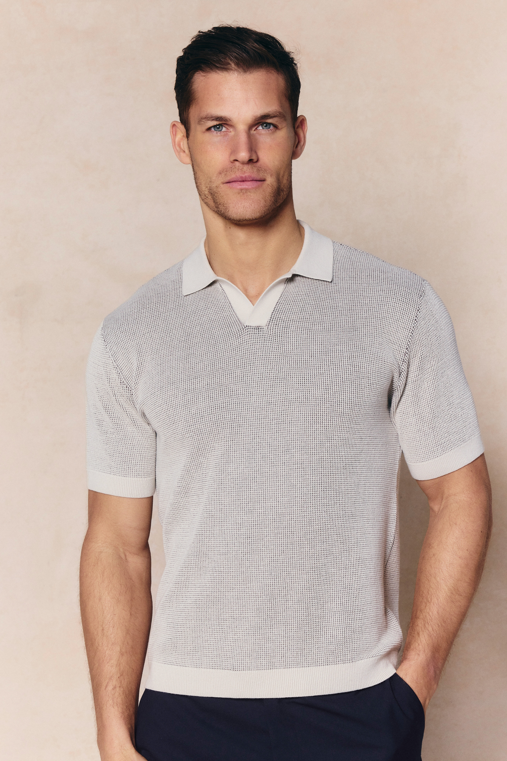 Man in Oscar Two Tone Double Knit Polo Shirt in neutral 100% cotton, relaxed open collar, ribbed trims.