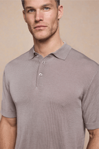 Man wearing a tailored sand Pablo Half Placket Short Sleeve Knitted Polo with ribbed sleeves and hem.