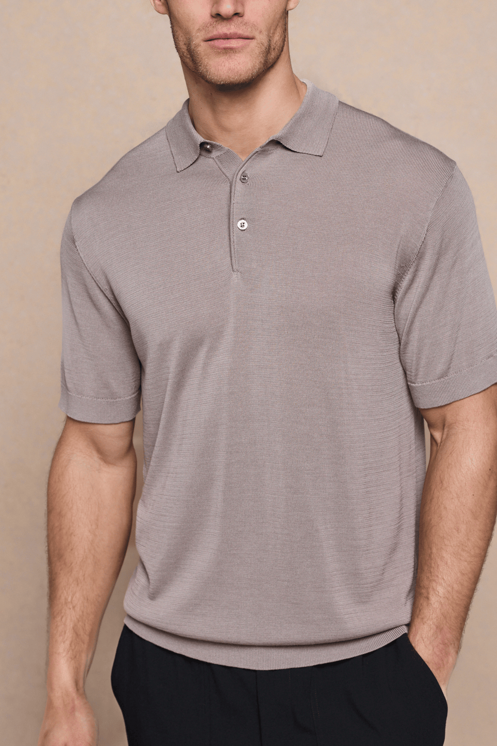Man wearing a tailored Pablo Sand Half Placket Short Sleeve Knitted Polo with ribbed sleeves and hem.
