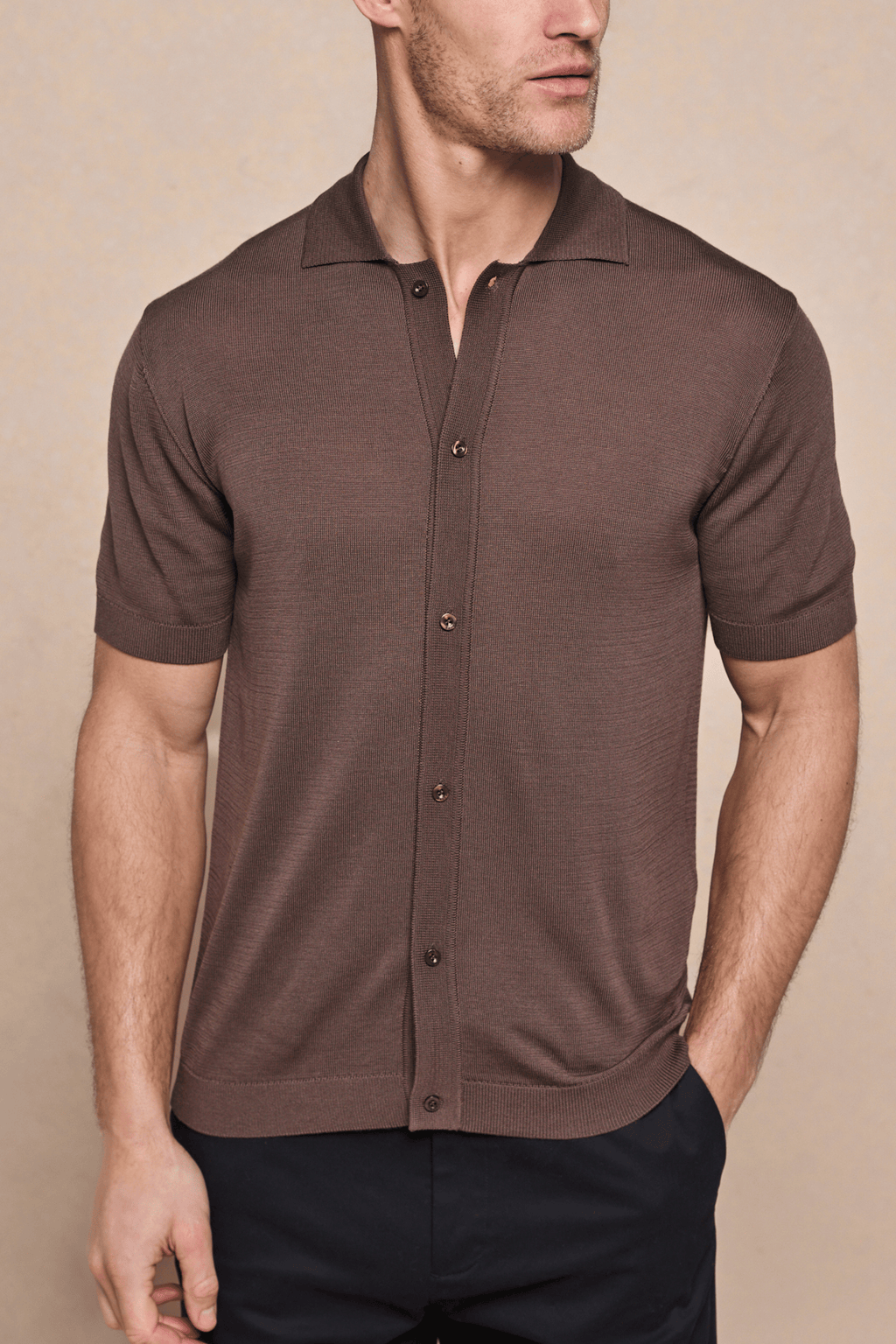 Brown Pedro knitted short sleeve shirt with full button-through front, ribbed sleeves, and hem.