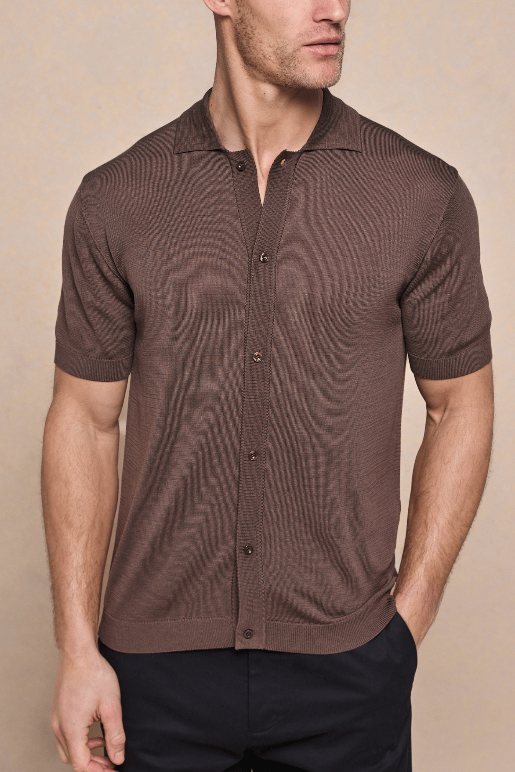 Brown Pedro knitted short sleeve shirt with full button-through front, ribbed sleeves, and hem.