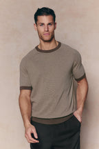 Man wearing a brown and beige striped linen blend crew neck t-shirt with dark trim.