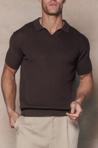 Men's Rapha brown cotton knit polo with open collar, short sleeves, and ribbed hem, paired with light trousers.
