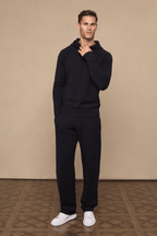 Man wearing a black knitted hoodie and matching Rowan Knitted Trousers with side pockets and drawcords.