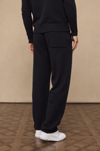 Black Rowan Knitted Trouser, ultra-soft yarn, with a back pocket, paired with white sneakers.