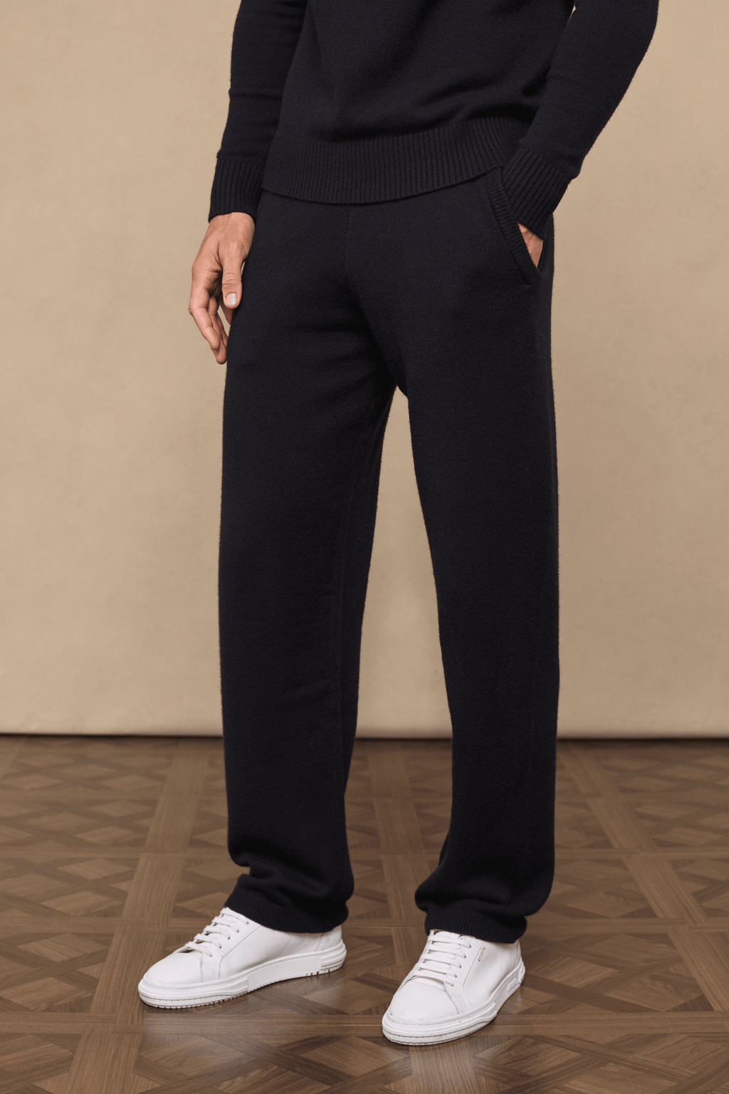 Black Rowan Knitted Trouser, ultra-soft yarn, with side pockets, worn by a model with white sneakers.