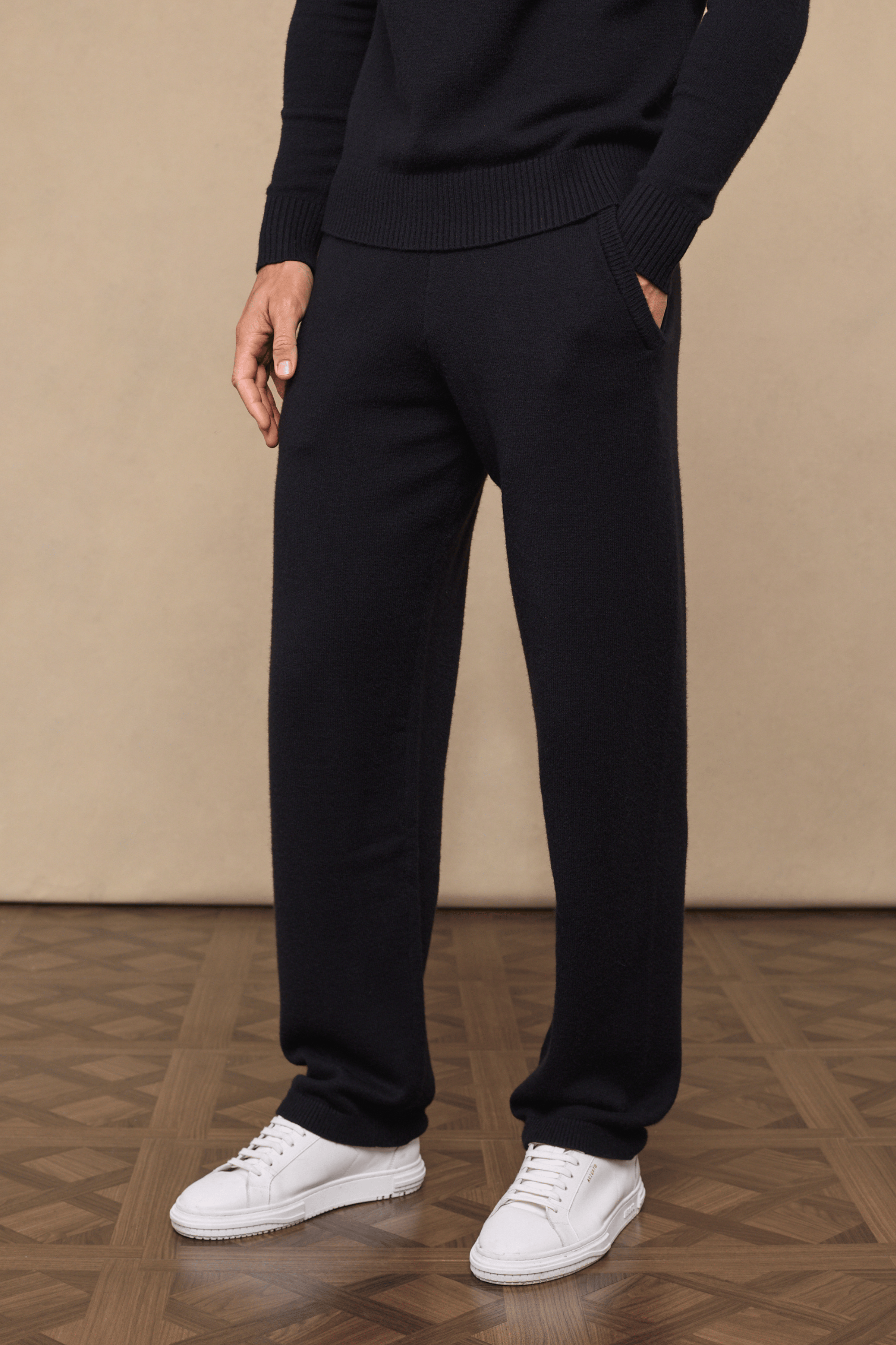 Black Rowan Knitted Trouser, ultra-soft yarn, with side pockets, worn by a model with white sneakers.