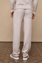 Man wearing oatmeal Rowan Knitted Trouser and matching sweater, showcasing back pocket and relaxed fit.