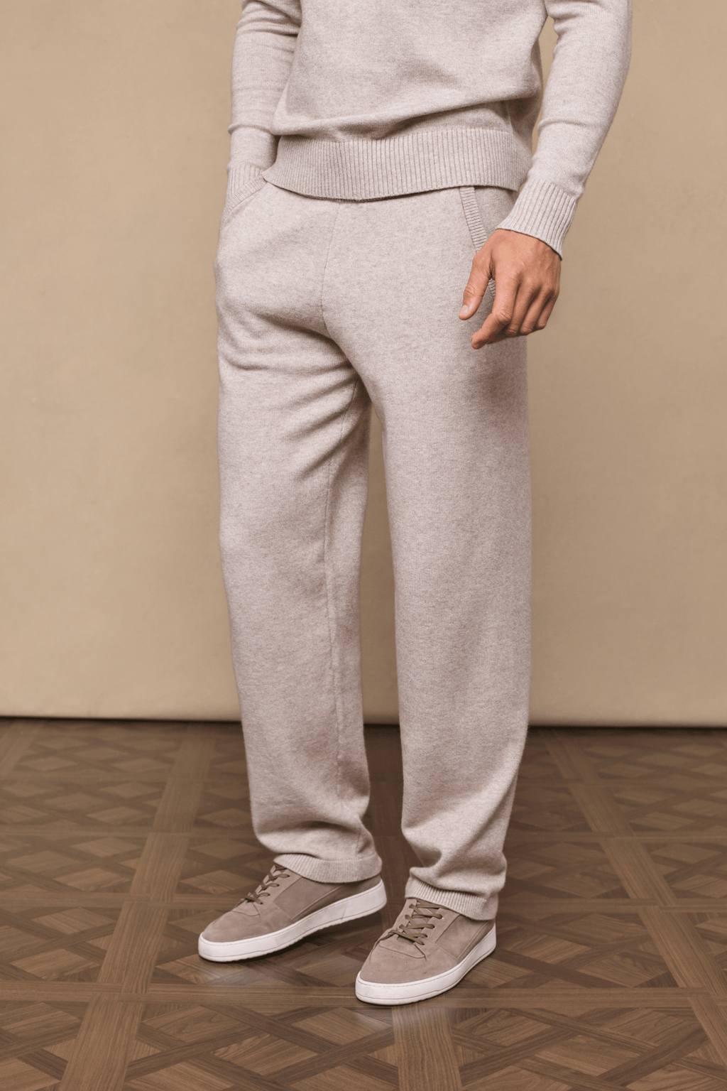 Man wearing oatmeal Rowan Knitted Trouser and matching sweater, showcasing soft texture and relaxed fit.